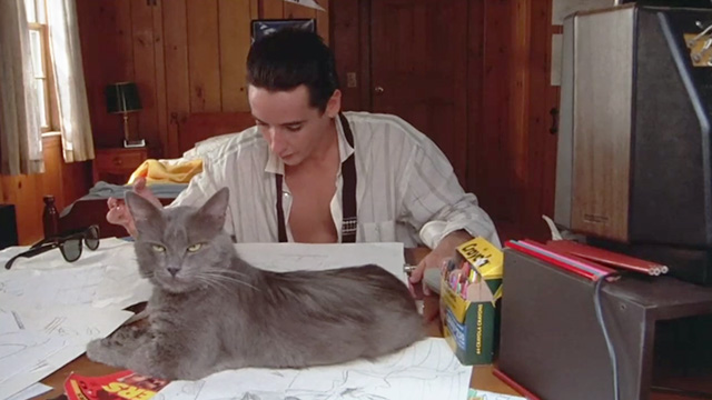 One Crazy Summer - long hair gray cat Morty sitting on desk in front of Hoops McCann John Cusack