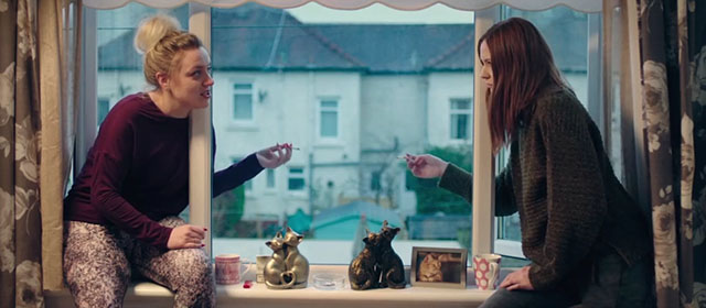 The Party's Just Beginning - Donna Rachel Jackson and Luisaidh Karen Gillan smoking on windowsill with cat statues and photo