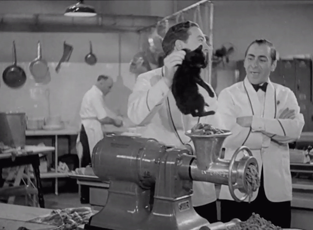 Pick a Star - black kitten picked up by scruff by Joe Jack Haley about to be put into meat grinder with Tony Benny Burt