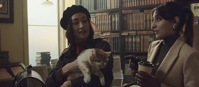 The Protégé - Anna Maggie Q holding ginger and white tabby cat with Seema Taj Atwal