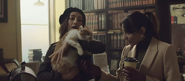 The Protégé - Anna Maggie Q holding ginger and white tabby cat with Seema Taj Atwal