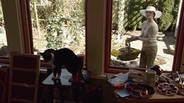 Secret Lives - tabby and white cat Cleo on table with Jill Daphne Zuniga outside