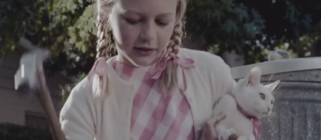 A Single Man - girl holding white cat while hammering