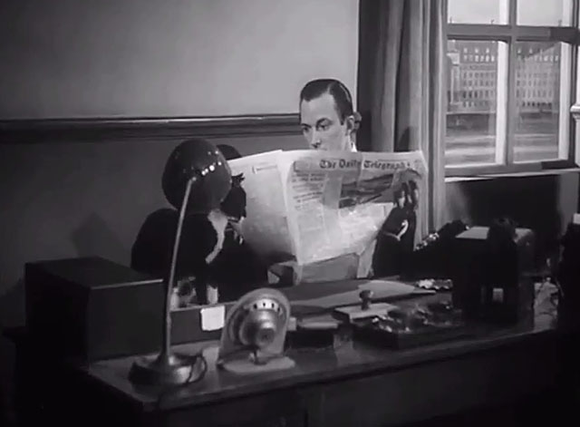 The Six Men - Hunter Michael Evans sitting at desk with tuxedo cat in tray