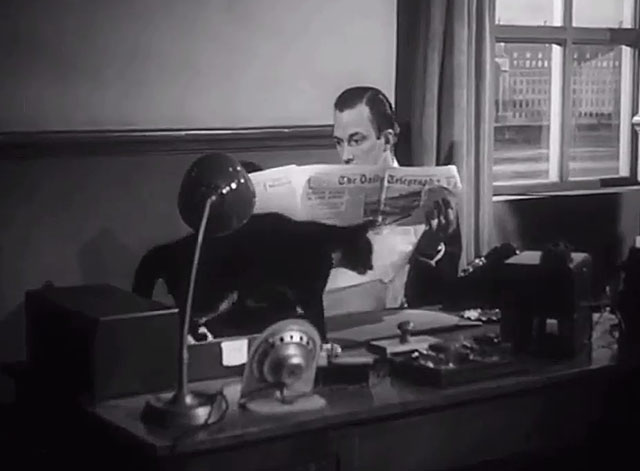 The Six Men - Hunter Michael Evans sitting at desk with tuxedo cat