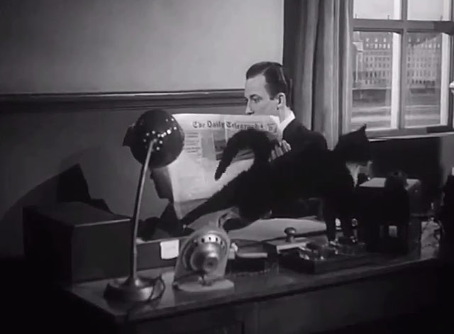 The Six Men - Hunter Michael Evans sitting at desk with tuxedo cat