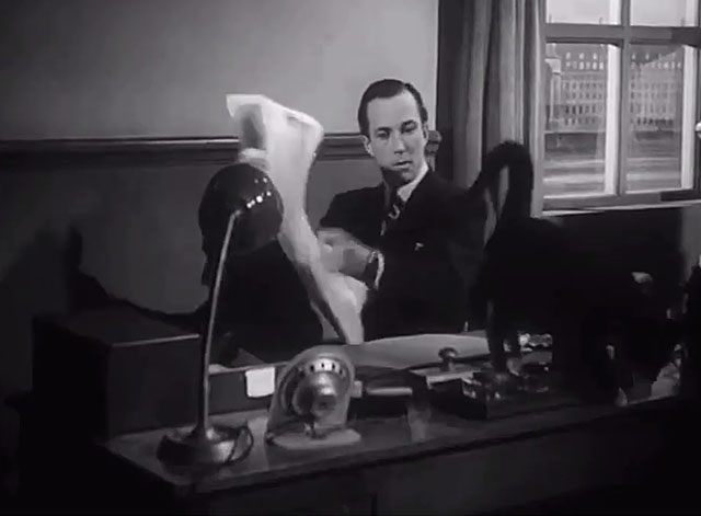 The Six Men - Hunter Michael Evans sitting at desk with tuxedo cat