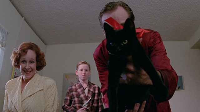 The Slayer - mom Ivy Jones, brother Richard Van Brakel and dad Newell Alexander with black kitten wearing red ribbon