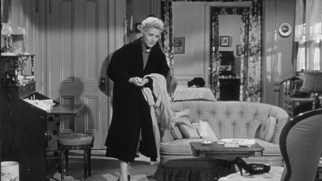 The Solid Gold Cadillac - tuxedo cat Mirabel on bed behind Laura Judy Holliday