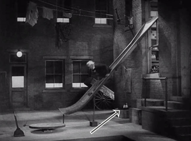 Soup to Nuts - white cat sitting in box in alley with string tied to tail as Uncle Otto Charles Winninger goes down slide