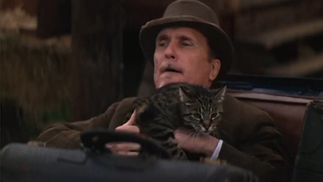 The Stars Fell on Henrietta - Mr. Cox Robert Duvall holding brown tabby cat Matilda in back of car