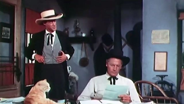 Stranger on Horseback - ginger tabby cat Orangey lying on desk in jailhouse with Rick Thorne Joel McCrea and Colonel Buck Streeter John Carradine