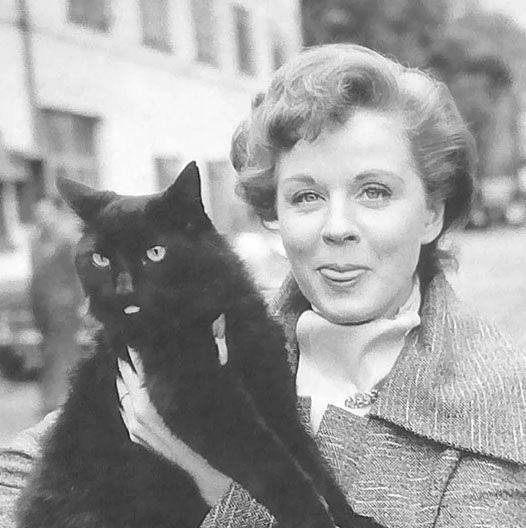 Touch and Go - actress Margaret Johnson as Helen holding longhair black cat Heathcliff on set