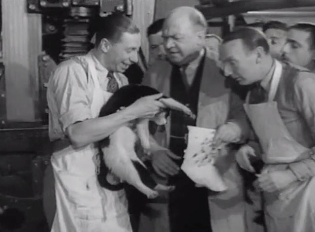 Trouble Brewing - George Formby showing men tuxedo cat's paws covered with ink