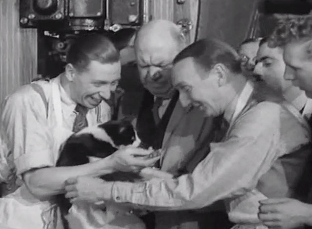 Trouble Brewing - George Formby showing men tuxedo cat's paws covered with ink