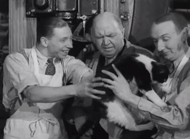 Trouble Brewing - George Formby handing tuxedo cat to man