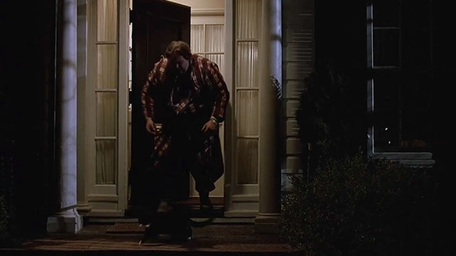 Uncle Buck - John Candy placing tuxedo cat outside house at night