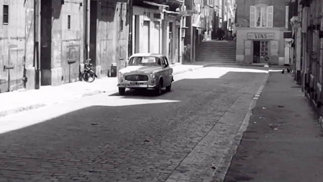 The Unvanquished - car turning corner onto street with black cats on sidewalk