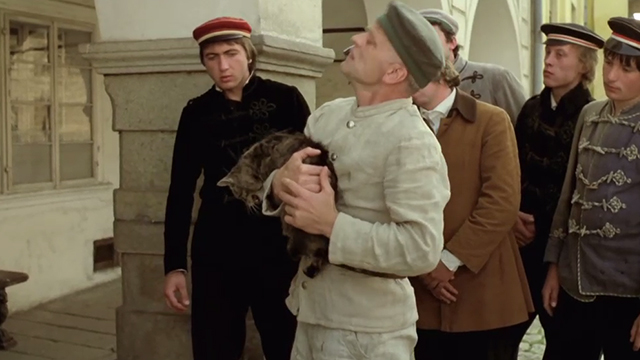 Woyzeck - Woyzeck Klaus Kinski holding onto panting tabby cat in front of male students