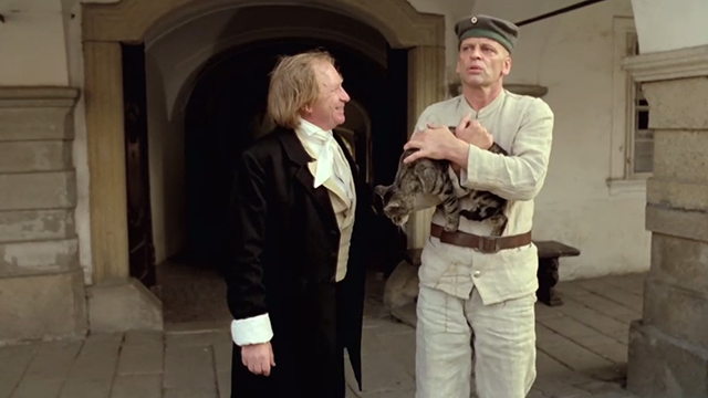 Woyzeck - doctor Willy Semmelrogge with Klaus Kinski holding tabby cat in front of building