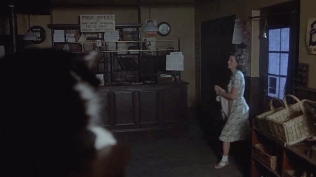 Yanks - tuxedo cat seen on shop counter in foreground as Jean Lisa Eichhorn enters