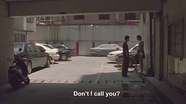 Yi Yi - cat by parked cars near young couple