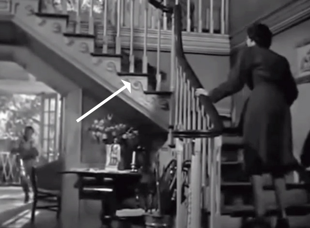 Young Widow - tabby cat running down stairs toward Joan Jane Russell