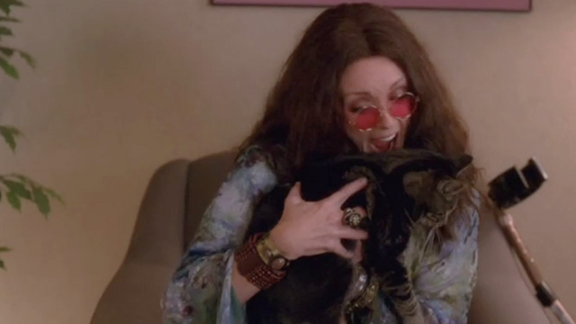 30 Rock - Retreat to Move Forward - Jenna Jane Krakowski dressed as Janis Joplin about to bite tabby cat