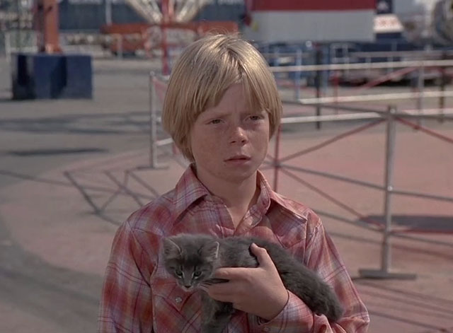 Charlie's Angels - To Kill an Angel - Skip Dennis Dimster holding grey tabby kitten at amusement park