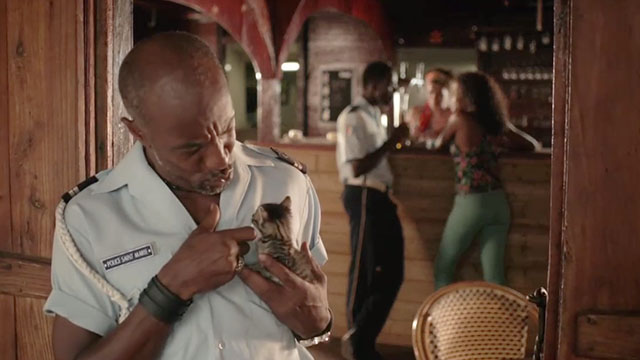 Death in Paradise - A Dash of Sunshine - Dwayne Danny John-Jules holding brown tabby kitten