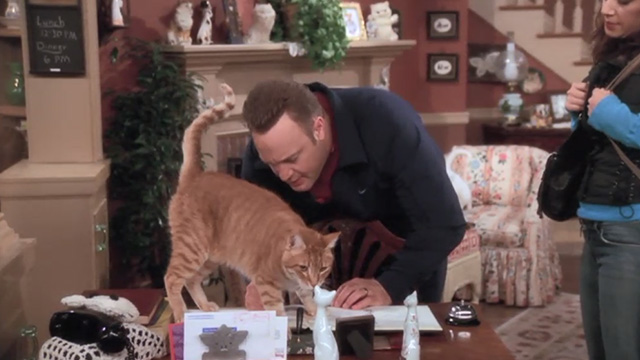 The King of Queens - Inn Escapable - Doug Kevin James tries to sign register with orange tabby cat Marmalade in way